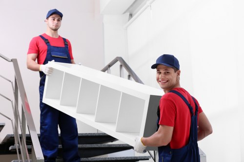 Removal team handling furniture during a flat move in Customhouse