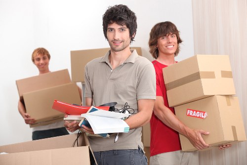 Packed moving boxes and furniture ready for house removals in Customhouse