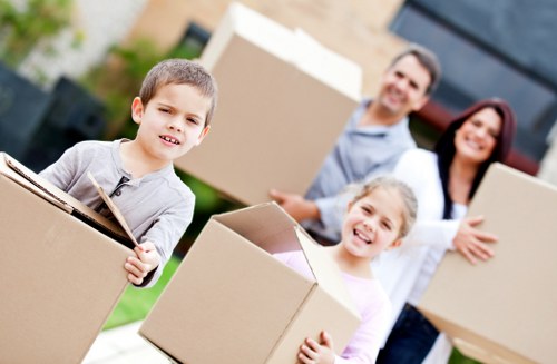 Customhouse removal team packing household items carefully for transport